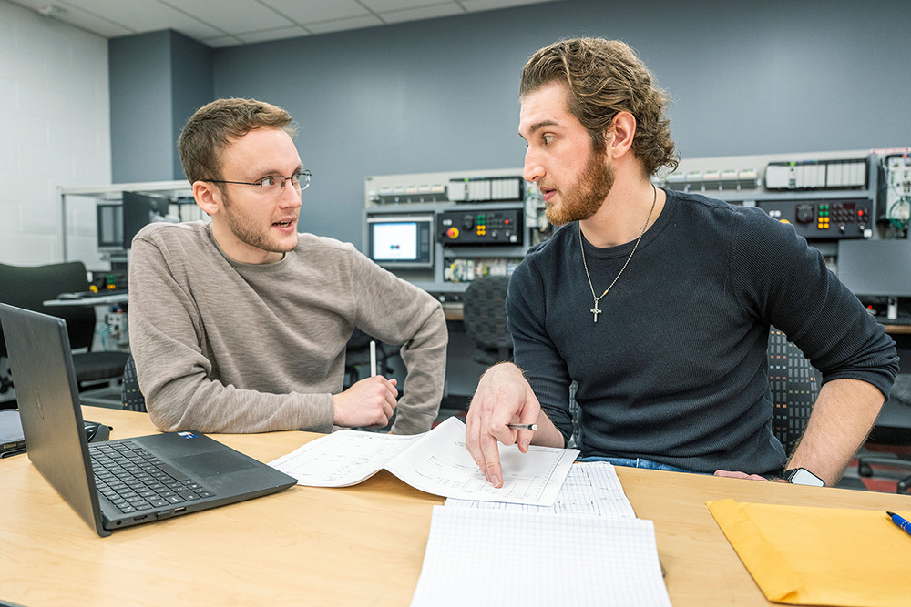Sam Ratvasky and Alec Vanderbilt working in a lab